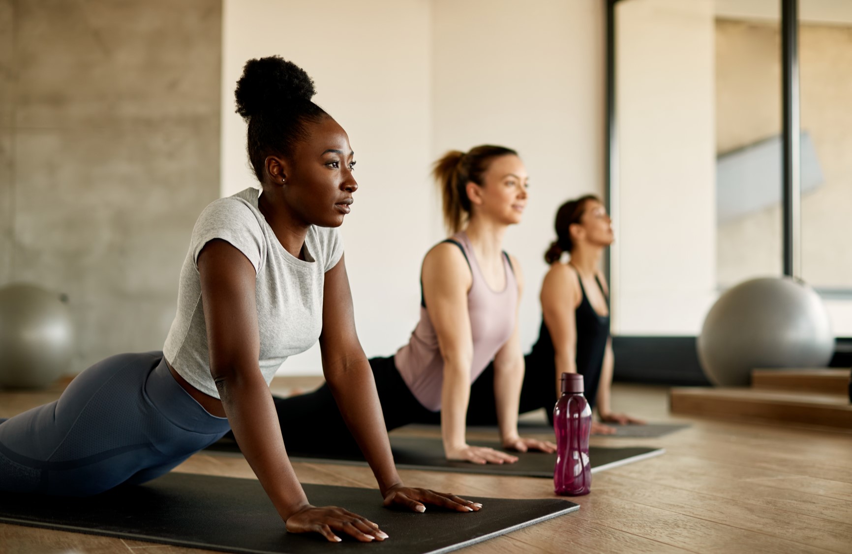 Three ladies doing yoga